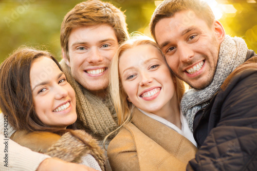 Photo: group of friends having fun in autumn park group of friends having fun in autumn park