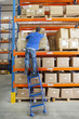 Photo: Portrait of smiling worker scanning box on production line in distribution warehouse Portrait of smiling worker scanning box on production line in distribution warehouse