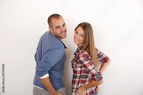 Photo: Smiling couple standing on white background Smiling couple standing on white background