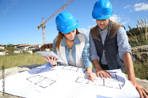 Photo: Construction people looking at blueprint Construction people looking at blueprint