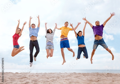 Photo: group of friends jumping on the beach group of friends jumping on the beach