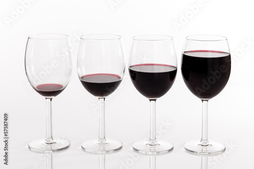 Photo: Glasses with different quantities of red wine Glasses with different quantities of red wine