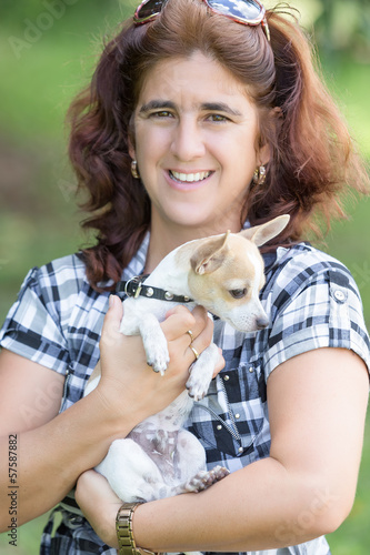 Photo: Woman hugging a small chihuahua dog Woman hugging a small chihuahua dog