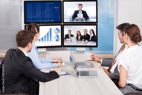Photo: Businesspeople Looking At Computer Screen Businesspeople Looking At Computer Screen
