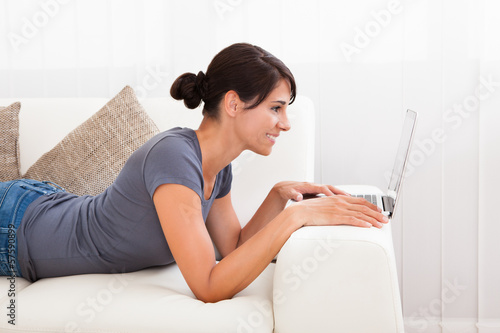 Photo: Woman With Laptop On Sofa Woman With Laptop On Sofa