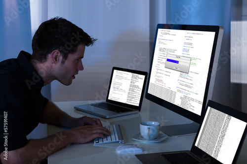 Photo: Man Working With Computer And Laptop Man Working With Computer And Laptop