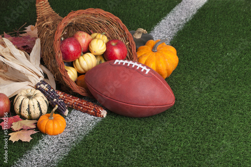 Photo: Football with a cornucopia on a grass field Football with a cornucopia on a grass field