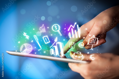 Photo: Hand touching tablet pc, charts concept Hand touching tablet pc, charts concept