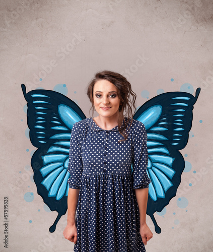 Photo: Young girl with butterfly blue illustration on the back Young girl with butterfly blue illustration on the back