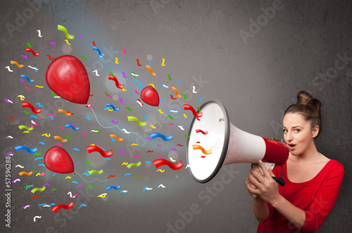 Photo: Young girl having fun, shouting into megaphone with balloons Young girl having fun, shouting into megaphone with balloons