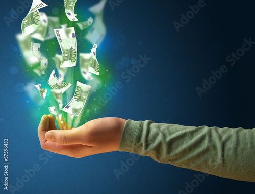 Photo: Glowing money in the hand of a woman Glowing money in the hand of a woman