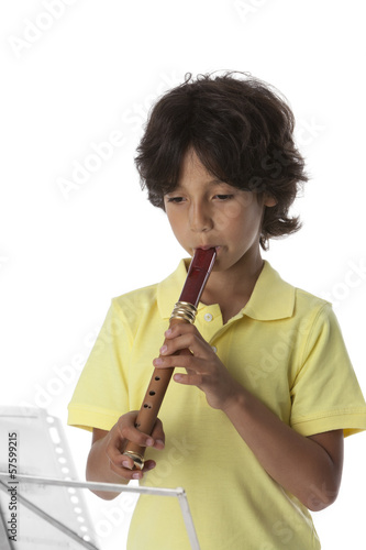 Photo: Little boy is playing the recorder Little boy is playing the recorder