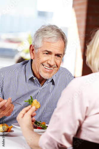 Photo: Man talking to woman in restaurant Man talking to woman in restaurant