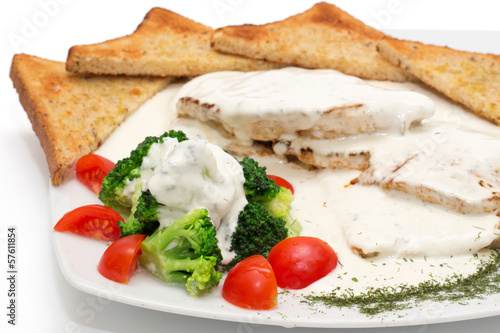 Photo: Chicken with gorgonzola, vegetables and bread on the plate Chicken with gorgonzola, vegetables and bread on the plate
