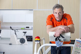 Photo: Portrait of runner holding mask and leaning on treadmill in sports science laboratory Portrait of runner holding mask and leaning on treadmill in sports science laboratory