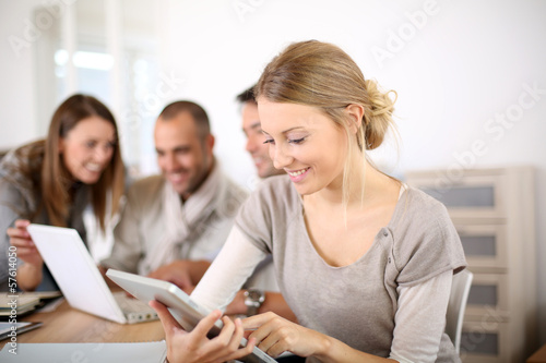 Photo: Young business girl working on tablet Young business girl working on tablet