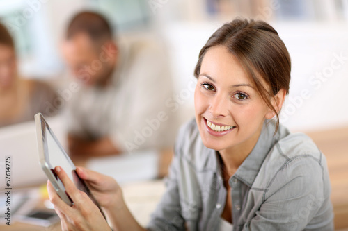 Photo: Young woman using tablet in business training Young woman using tablet in business training