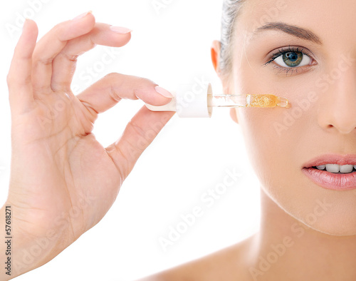 Photo: Beautiful woman applying cosmetics Beautiful woman applying cosmetics