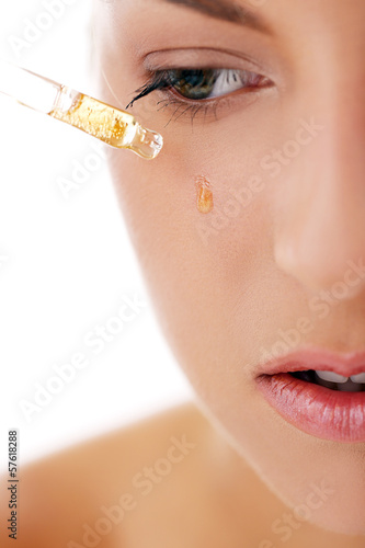 Photo: Beautiful woman applying cosmetics Beautiful woman applying cosmetics