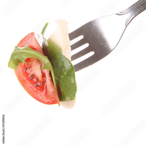 Photo: Tomato, spinach & rucola, mozzarella on fork on white Tomato, spinach & rucola, mozzarella on fork on white