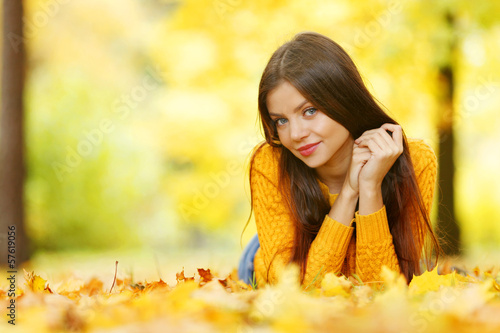 Photo: Girl laying on autumn leafs Girl laying on autumn leafs