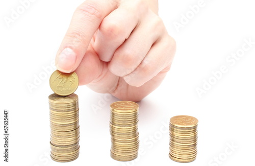 Photo: Hand put coins to stack of coins Hand put coins to stack of coins