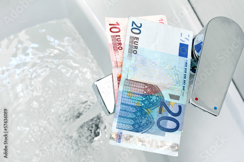 Photo: euro money on the tap and flowing water euro money on the tap and flowing water