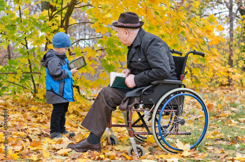 Photo: Young boy with his disabled grandfather Young boy with his disabled grandfather