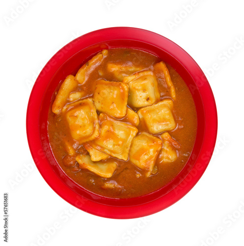 Photo: A large serving of ravioli in tomato sauce in a red bowl A large serving of ravioli in tomato sauce in a red bowl