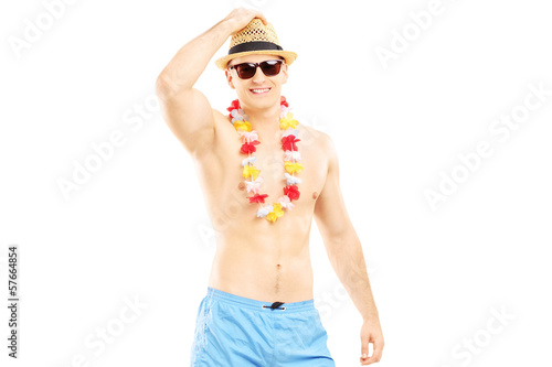 Photo: Handsome guy in swimming shorts and hat looking at camera Handsome guy in swimming shorts and hat looking at camera