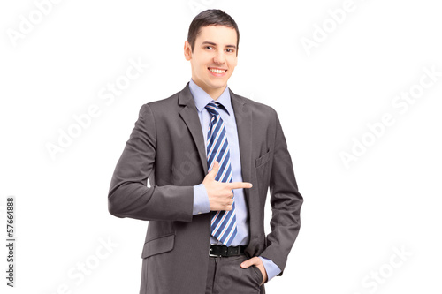 Photo: Young businessman standing and pointing Young businessman standing and pointing