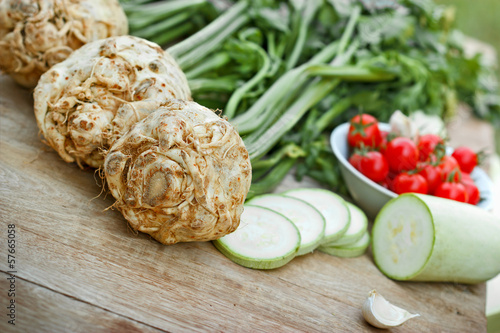 Photo: Organic elery (root celery and leaves of celery) on a table Organic elery (root celery and leaves of celery) on a table