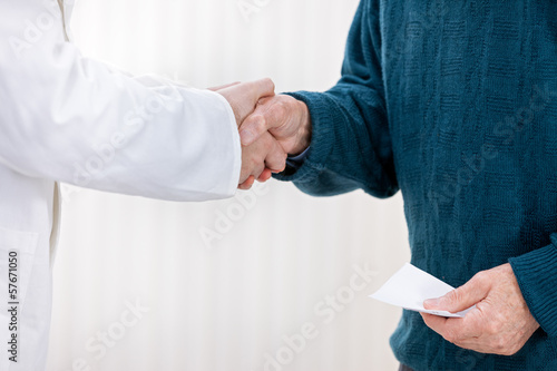 Photo: doctor shaking with patient doctor shaking with patient