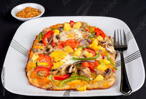 Photo: Hot fresh vegetarian flatbread pizza with eggs. Hot fresh vegetarian flatbread pizza with eggs.