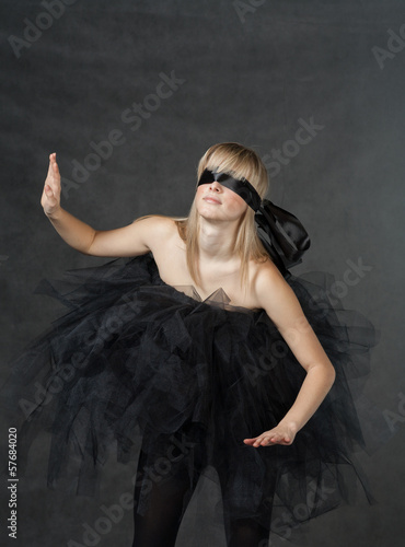 Photo: female beauty-portrait with tutu in front of a dark background female beauty-portrait with tutu in front of a dark background