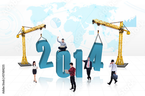 Photo: Business people building the new year 2014 Business people building the new year 2014