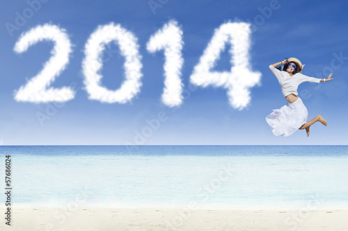 Photo: Woman jumping with clouds of 2014 Woman jumping with clouds of 2014