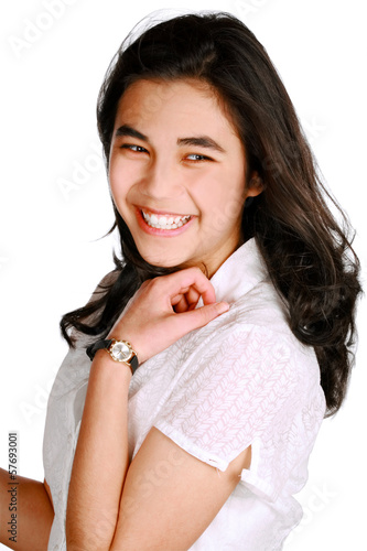 Photo: Beautiful biracial teen girl in casual pose, looking over should Beautiful biracial teen girl in casual pose, looking over should