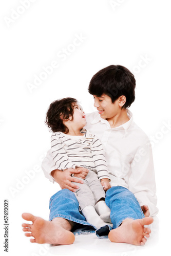 Photo: Big brother holding disabled two year old child. Child has cereb Big brother holding disabled two year old child. Child has cereb