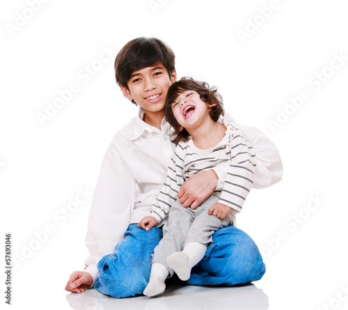 Photo: Big brother holding disabled two year old child. Big brother holding disabled two year old child.