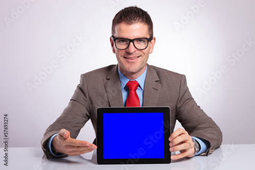 Photo: young business man presents his tablet young business man presents his tablet