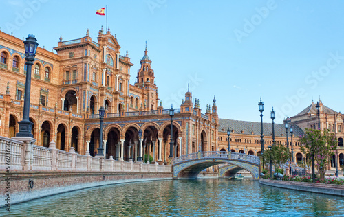 Photo: Tourists go boating on channel on Plaza de Espana in Seville Tourists go boating on channel on Plaza de Espana in Seville