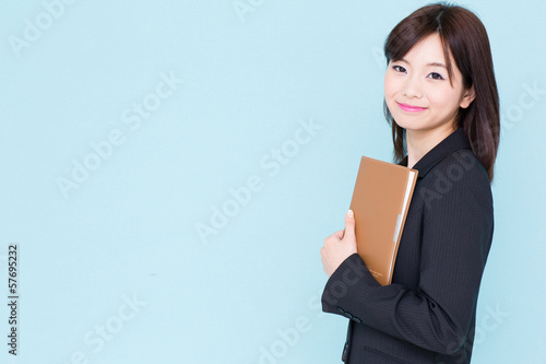 Photo: asian businesswoman on blue background asian businesswoman on blue background