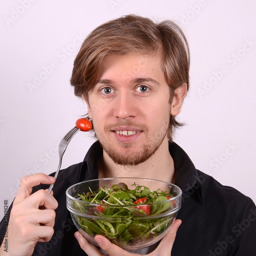Photo: man with fresh salad man with fresh salad