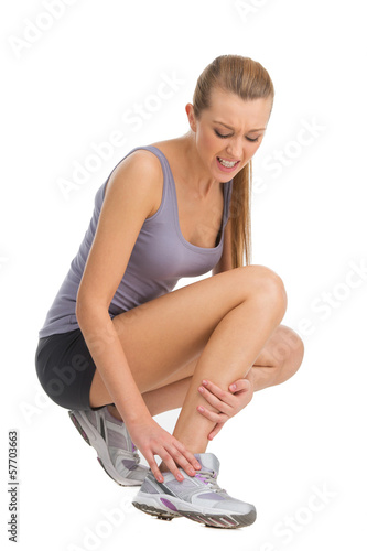 Photo: Sport woman feeling pain in her ankle. Sport woman feeling pain in her ankle.