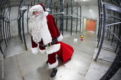 Photo: last Santa Claus loosing gifts from sack in empty storehouse last Santa Claus loosing gifts from sack in empty storehouse