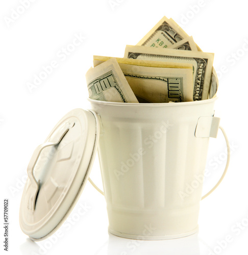 Photo: Money in trash can, isolated on white Money in trash can, isolated on white