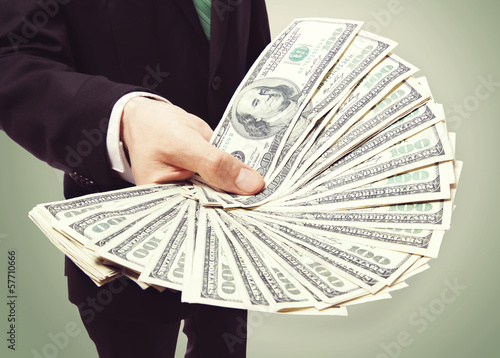 Photo: Business Man Displaying a Spread of Cash Business Man Displaying a Spread of Cash