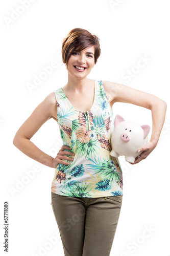 Photo: Beautiful woman holding a piggybank Beautiful woman holding a piggybank