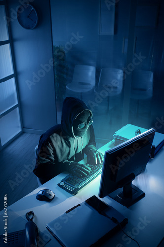 Photo: Hacker stealing data from computer Hacker stealing data from computer